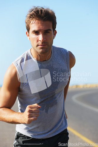 Image of Sports, sweat and man athlete in mountain running for race, marathon or competition training. Fitness, workout and body of male runner doing a cardio exercise for health or wellness in outdoor nature