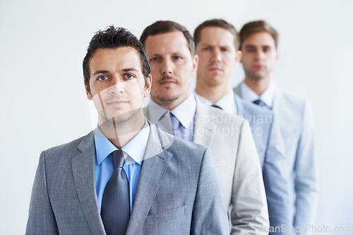 Image of Men, portrait and serious for job interview, finance career and ready for selection process. Worker, corporate accountant in suit or professional in workplace, colleagues in background and confident