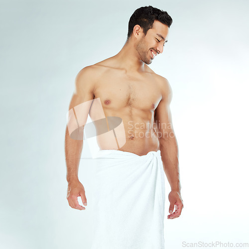 Image of Shower, towel and happy fitness man in studio for wellness, hygiene or body care routine on white background. Cleaning, grooming or muscular Japanese male model with pamper, cosmetics or treatment