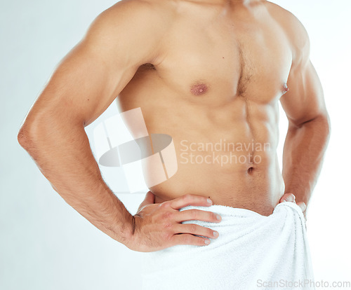 Image of Fitness, body and closeup of man in a towel in studio for shower, wellness or grooming on white background. Chest, stomach and male model in a bathroom for cosmetic, care or cleaning with a sixpack