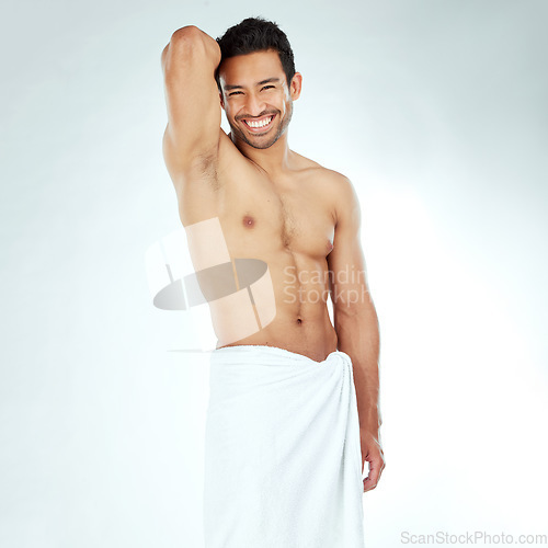 Image of Portrait, body and happy asian man with a towel in studio for shower, wellness or cosmetics on white background. Bathroom, face and Japanese male model smile for luxury pamper, grooming or treatment