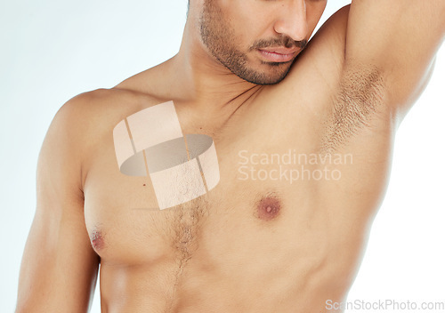 Image of Body, closeup and man smelling armpit in studio for wellness, hygiene or control on white background. Underarm, care or guy model with sweat, scent or odor check after shower, cleaning or grooming