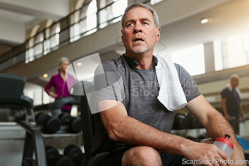 Image of Fitness, break and tired senior man at a gym with water after training, exercise or challenge. Sports, fatigue and elderly male person with liquid for hydration, recovery or resting from workout