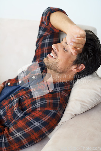 Image of Happy, relax and man on sofa in home for afternoon nap, resting and sleeping in living room. Asleep, eyes closed and tired person on couch lying for fatigue, comfortable and wellness in apartment