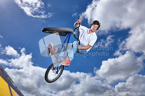 Image of Trick, jump and man with bike in sky at park, event or competition for sport with risk, energy or freedom. Mockup, space or person in air with fearless stunt on bicycle for fun adventure in summer