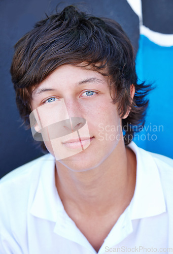 Image of Cool, teenager and portrait of skater on wall in summer, vacation or relax outdoor on holiday. Urban, teen and face of serious kid with edgy fashion, long hairstyle and streetwear for skatepark