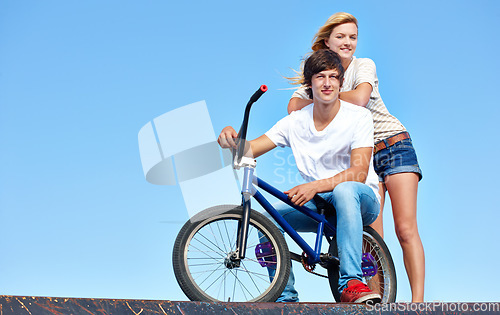 Image of Happy, friends and portrait of teenager at skatepark in summer on vacation or holiday with bicycle on sky. Cool, girl and boy on ramp with bike and smile for fun ride together in city mock up space