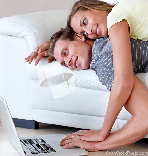 Image of Couple, couch and laptop for movie in home, scroll and relax together for bonding, love and care. Man, woman and lying on back, sofa and living room with computer on floor to watch film in house