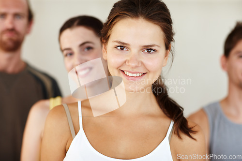 Image of Portrait, smile or yoga and woman with a group of people in a studio for health, wellness or mindfulness. Fitness, exercise or pilates with happy young friends in gym class for holistic training