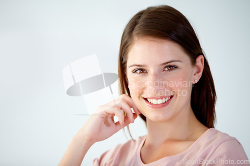 Image of Portrait, face of woman and smile in studio to relax for break, rest and confident personality on white background. Happy, young and beautiful model with good mood, pride and optimism at mockup space