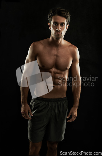 Image of Topless, black background or portrait of man with six pack, strong abs or stomach in studio. Fitness model, cool or ripped male person with healthy body, dark shadow or abdomen muscle for wellness