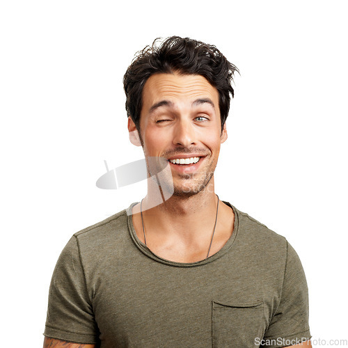 Image of Face, smile and playful wink with a man in studio isolated on a white background for comedy or humor. Comic, funny and happy with a goofy young person acting silly as a character for a carefree joke