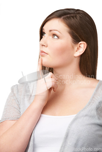 Image of Face, vision and future with a woman and thinking in studio isolated on white background for planning. Plus size, problem solving and brainstorming with a young body positive model looking thoughtful