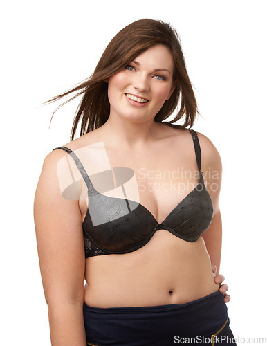 Image of Portrait, smile and bra with a plus size woman in studio isolated on a white background for body positivity. Beauty, wind and a happy young model looking natural or confident in her underwear