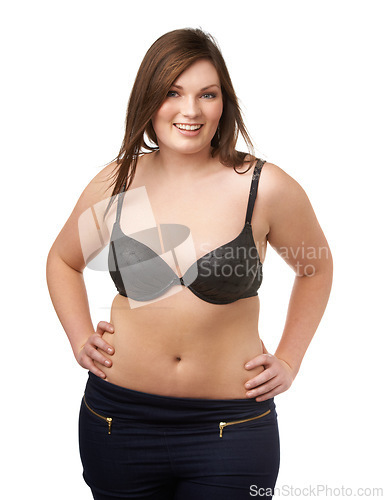 Image of Portrait, happy and bra with a plus size woman in studio isolated on a white background for body positivity. Beauty, smile and a confident young model looking natural in her underwear for wellness