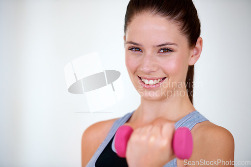 Image of Woman, smile and portrait with dumbbells in studio for health training, fitness and relax wellness with exercise. Young person, happy and face with hand weights with commitment by white background