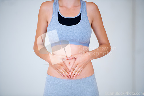 Image of Heart, hands on stomach and woman for fitness, workout and exercise to lose weight. Happy, gut health and person with emoji, symbol or shape on tummy for wellness, digestion and diet for healthy body