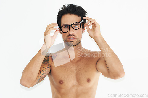 Image of Portrait, body and glasses with an awkward man in studio isolated on a white background to wake up. Vision, eyewear and a shirtless young person looking confused, unsure or surprised in the morning