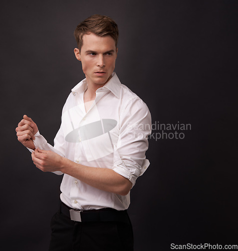 Image of Fashion, studio man and thinking of fancy clothes for semi formal outfit, attire or confident in classy, elegant or stylish apparel. Fix dress shirt, mockup space or model choice on black background