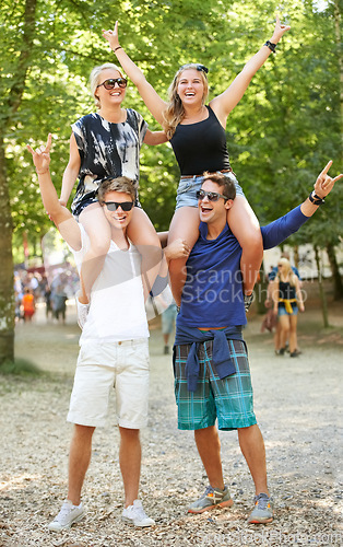 Image of Couple, man and carrying woman on shoulders at music festival with cheers for celebration in woods. Happy, people or rock n roll portrait at social, event or men support girlfriends for fun and games