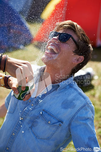 Image of Music festival, alcohol and man with beer outdoors splash for drunk party, celebration and camp event. Happy, excited and person with beverage spray at musical concert for freedom, wild and games