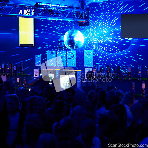 Image of People, crowd and dancing in nightclub or party with lightning, disco ball and music for entertainment. Event, festival or rave on dance floor with energy, group and performance for nightlife or club