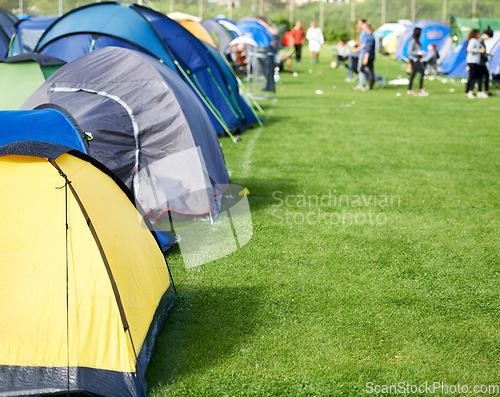 Image of Music festival, camping and tents in park with people in summer, holiday or field at concert in countryside. Camp, site or adventure shelter on grass in woods or group at carnival in morning of rave