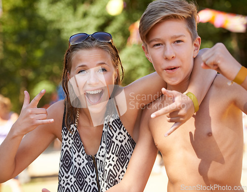 Image of Crazy, teenager and portrait of friends in park at music festival with rock n roll sign in summer. Hands, girl and boy in hug with freedom on vacation, holiday or smile for concert adventure in woods