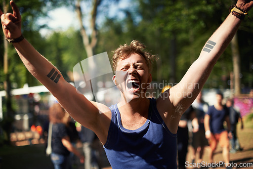 Image of Excited, cheers and man at music festival with nature, smile and fan in forest for concert event. Relax, happy celebration at outdoor party with freedom and adventure, person with trees and scream.