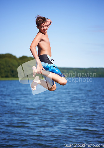 Image of Portrait, jump and ocean with water, vacation and excited with happiness, weekend break and movement. Person, outdoor and guy with water, cheerful and extreme with nature, seaside and energetic