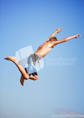 Image of Jumping, blue sky and man with energy, outdoor and excited with nature, environment and water. Person, outside and guy with vacation, mockup space and lake with summer, weekend break and excitement