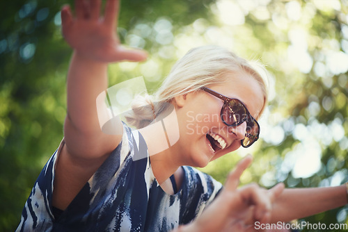 Image of Nature, dance or happy woman in music festival on holiday vacation to relax with smile in park. Shoulders, sunglasses or excited girl with freedom or youth culture for a fun party celebration event