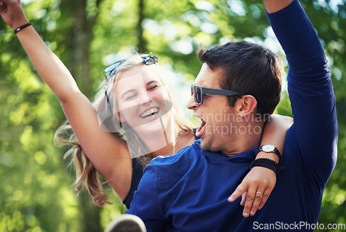 Image of Piggyback, dance or happy couple in nature on holiday vacation to relax with smile in park together. New year, man screaming or excited woman with freedom, connection or energy for fun celebration