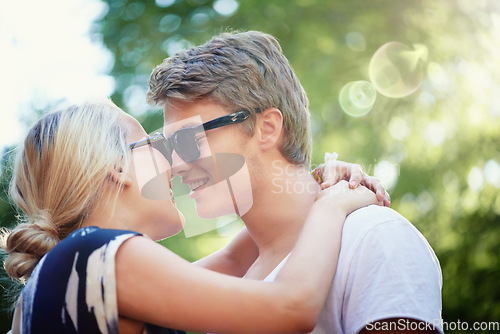 Image of Happy couple, holiday or hug for love in park, nature or outdoors on a romantic date for support. Wellness, relationship or man with woman, smile or trust for kiss, care or freedom together outside