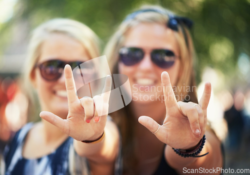 Image of Rock, hands or portrait of friends in music festival on holiday vacation together to relax with smile. Party, reunion celebration or excited gen z women with devil horns for a fun memory or event