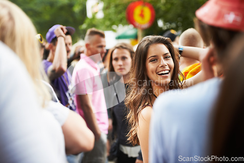 Image of Crowd, nature festival portrait and happy woman having fun, natural outdoor wellness and smile at social gathering. Forest music concert, audience and girl vacation, entertainment or woods rave event