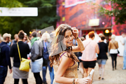 Image of Music, festival and portrait of woman at a concert, field with crowd and audience or excited fan at event. Happy, girl and walking to stage or dancing with drink at party with alcohol and celebration