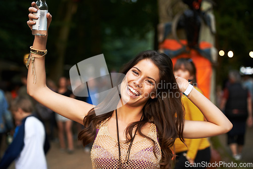 Image of Outdoor music festival, night portrait and happy woman having fun, happiness and smile at event. Dark rave concert, alcohol drinks and person spring break vacation, entertainment or social gathering