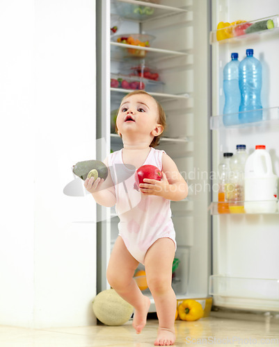 Image of Toddler, little girl and food from fridge in kitchen for running with fresh, fruit and vegetable in hand. Youth, child and curious for organic, natural and nutrition for development of motor skill