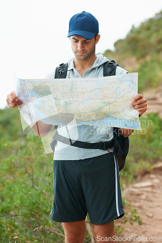 Image of Man, hiking and map for direction, nature and guide on trail, fitness and exercise on holiday. Male person, lost and documents for information, travel and journey or adventure to forest for cardio