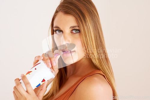 Image of Woman, drinking or soda with confident portrait in studio mockup or wellness on vacation. Model, smoothie or face on sip straw for fizzy pop, thirsty or sweet seltzer for teenager by white background