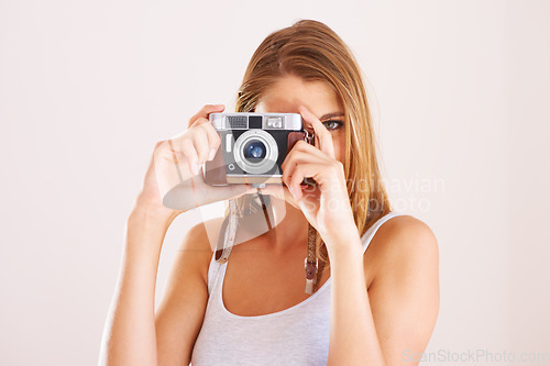 Image of Photographer, woman and retro camera in studio for photoshoot, content creation and paparazzi magazine on white background. Portrait, journalist and photography with lens for creative art production