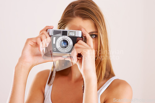 Image of Photography, woman and retro camera in studio for content creation, magazine photoshoot and paparazzi on white background. Portrait, media and creative photographer with lens for art, skills or hobby