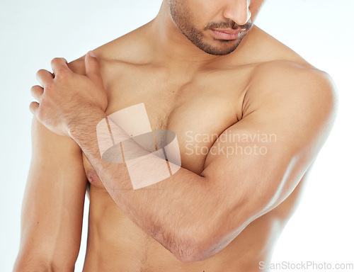 Image of Body, closeup and man in studio for wellness, cleaning or grooming, routine and treatment against white background. Chest, cosmetics or male model hand touching soft, smooth or glowing skin results