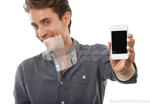 Image of Business man, portrait and phone screen for advertising space, presentation or mobile newsletter in studio on white background. Happy worker, smartphone mockup or review sales information coming soon