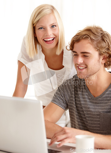 Image of Laptop, smile and ecommerce with a young couple in their apartment for accounting or budget planning together. Computer, bank or finance with a happy man and woman in their home for investment growth