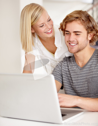 Image of Laptop, smile and planning with a young couple in their apartment for research or investment together. Computer, bank or ecommerce with a happy man and woman in their home for growth or development