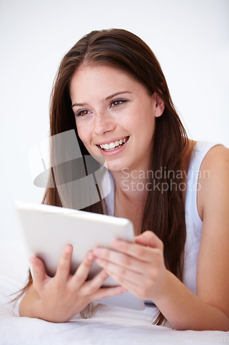Image of Woman, tablet and thinking on bed of online search, social media and streaming service for film choice or movies. Happy young person with ideas or home inspiration on digital technology in bedroom