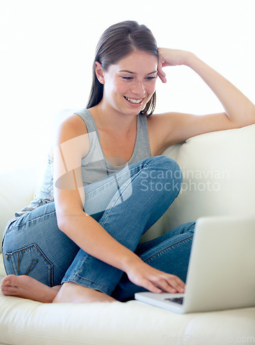 Image of Happy woman, laptop and relax on sofa for internet, education results or search for sign up information on website. Young student on couch and typing on computer for subscription or streaming at home