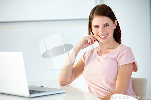 Image of Happy, business woman and portrait at laptop in office at desk to review online research, website and social media connection in creative startup. Young designer working on computer in digital agency